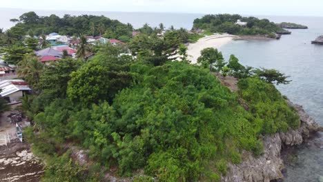 Filipino-Fishing-Village-on-Shore-of-Remote-Malapascua-Island,-by-Drone