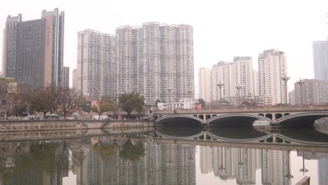 Chengdu-capital-city-of-the-Chinese-province-of-Sichuan,-Anshun-Bridge-over-the-Jin-river-with-modern-skyline-skyscraper-building-,-panoramic-view