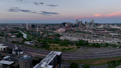 Twilight-aerial-view-over-I-25-of-Elitch-Gardens,-Auraria-and-downtown-Denver