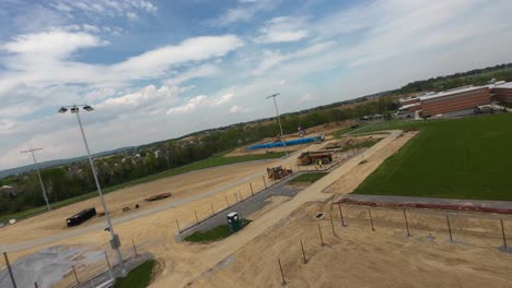 Drone-flyover-construction-site-for-new-sport-area-at-american-school