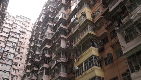 Dense-Apartment-Buildings-In-Residential-Neighborhood-In-Hong-Kong-City,-Panning-Low-Angle-View