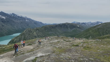 Tourists-going-on-a-hike-in-the-Norwegian-mountains-with-beautiful-scenery-in-the-background