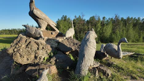 Explore-the-serene-beauty-of-Yakutia-as-stunning-wooden-sculptures-of-local-wildlife-emerge-from-the-landscape,-capturing-the-essence-of-nature-at-sunrise