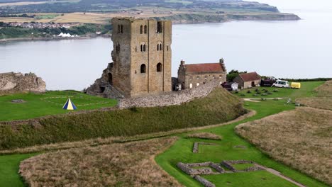 Aerial-drone-view-of-Scarborough-Castle-in-Scarborough,-North-Yorkshire-taken-early-morning-on-an-overcast-day-in-summer