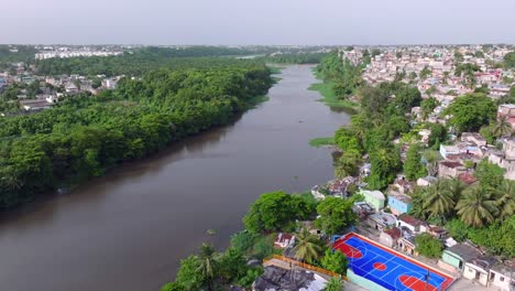 Stunning-aerial-drone-views-of-the-Isabela-River-alongside-the-Capotillo-neighborhood-in-Santo-Domingo