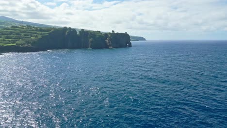 Agricultural-landscape,-seaside-cliffs-and-blue-ocean-at-Azores,-wide-aerial