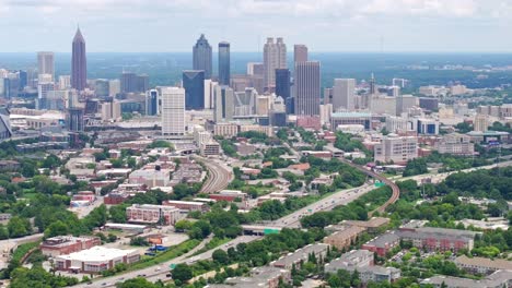 Establishing-drone-shot-of-Downtown-Atlanta-skyline-and-skyscrapers,-street-view,-neighbourhood-with-urban-parks-and-trees