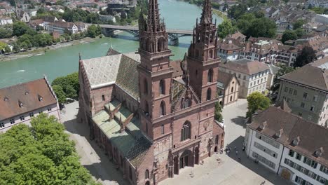 4K-Drone-Video-of-Historic-Church-Entrance-and-Plaza-in-Basel,-Switzerland-along-Rhine-River