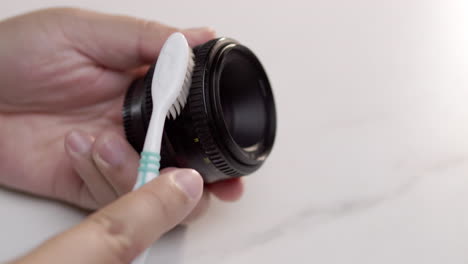 Cleaning-the-camera-ring-from-dust-with-toothbrush