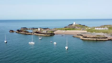 Yachten,-Die-Eine-Luftaufnahme-Erstellen,-Vertäut-Am-Atemberaubenden,-Friedlichen-Strand-Der-Walisischen-Insel-Ynys-Llanddwyn