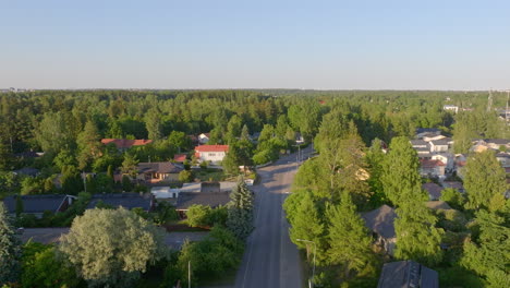 Aerial-view-backwards-over-empty-streets-in-the-neighborhoods-of-sunny-Helsinki