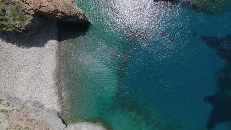 4K-Top-Down-Aerial-of-beautiful-bay-in-Junco-cove-beach,-Panarea,-Italy