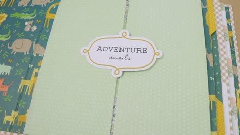 Showing-a-colorful-baby-themed-scrapbook-with-word-adventure