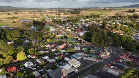 Aerial-establishing-shot-of-Tasmanian-city-on-island-with-scenic-fields-in-Background