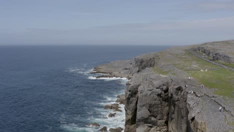 Flyover-the-steep-ocean-cliffs-at-The-Burren,-rugged-nature-in-Ireland