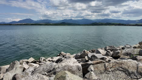 Blue-lake-surrounded-by-rocks-and-mountains-under-clear-sky