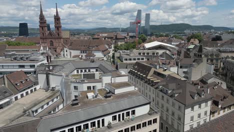 4K-Drone-Video-of-Roof-Tops-and-Construction-Cranes-on-Skyline-of-Basel,-Switzerland