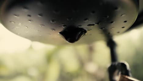 Close-up-of-a-slow-dripping-Robusta-coffee-maker-in-Vietnam-outside-in-a-garden