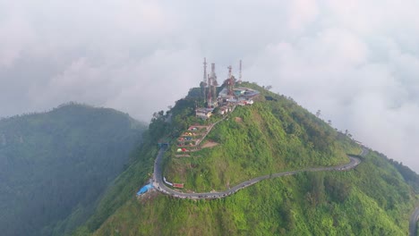 Aerial-view-of-Telomoyo-Mountain-with-tower-building-on-the-peak-with-sea-of-cloud