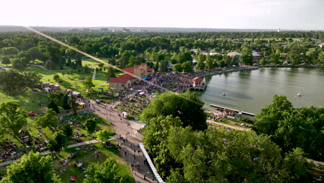 Sweeping-drone-view-over-City-Park-Jazz-community-event-in-Denver-at-Ferril-Lake