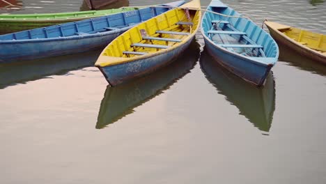 Colourful-Rowing-Boats-Close-Up-on-Phewa-Lake-in-Pokhara-at-Sunset-in-Nepal,-Beautiful-Fewa-Lake-Colorful-Tourist-Boat-Trip-Close-Up-Tight-Shot