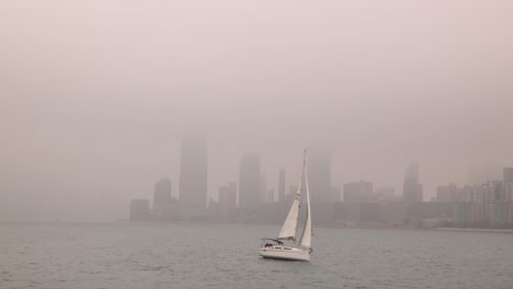 Sailboat-Sailing-Along-Hong-Kong-Coast-With-Air-Pollution-Smog-In-Sky,-Wide-View