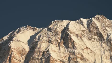 Sunny-Snowcapped-Mountains-Close-Up,-Climate-Change-of-Sun-Melting-Snow-on-Snowy-Himalayas-Mountains-Showing-Warming-Up-of-the-Planet-with-Sunshine-Shining-and-Blue-Sky-on-Sunny-Day