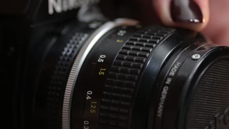 Macro-of-turning-a-lens-adjustment-focus-ring-of-an-old-retro-film-camera