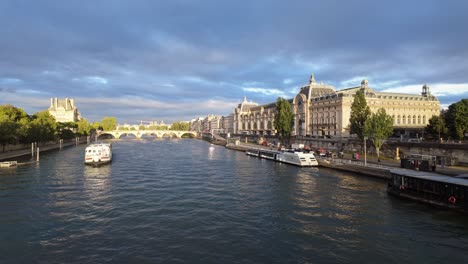 Cityscape-of-downtown-Paris-from-the-Seine-River-with-the-Orsay-Museum-and-the-Pavillon-de-Flore-buildings-in-the-background-before-sunset