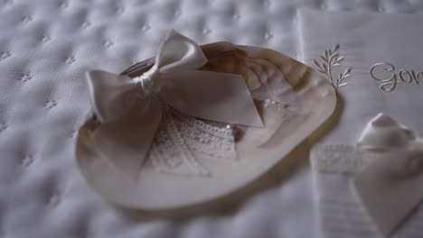 Baptismal-seashell-with-satin-ribbon-and-lace-on-a-soft-quilted-background