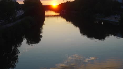 Sunset-over-Saar-river-Germany,-Saarbrucken-city,-sky-reflexion-in-water