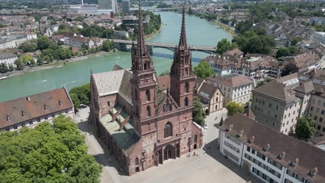 4K-Drone-Video-of-Historic-Church-Entrance-and-Plaza-in-Basel,-Switzerland-along-Rhine-River