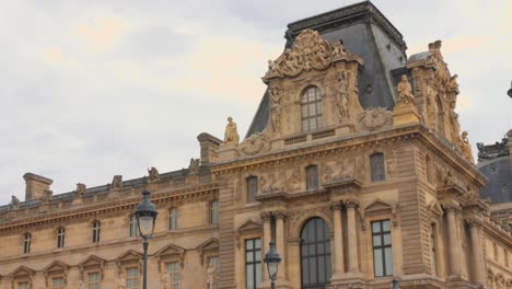 The-Louvre-Museum-in-Paris-with-intricate-architecture-under-a-cloudy-sky