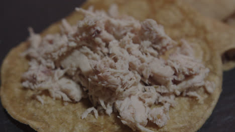 Beautiful-slow-motion-super-close-up-shot-of-an-unsealed-shredded-chicken-tortilla-in-a-restaurant