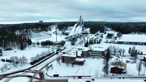 Aerial-view-rising-in-front-of-Salpausselka-ski-center,-winter-in-Lahti,-Finland