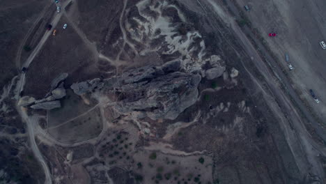 Top-down-shot-of-rocky-terrain-and-roads-in-Cappadocia,-Turkey