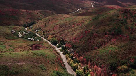 Aerial-drone-shot-of-roads-winding-through-the-mountain-range-in-Salt-Lake-City-with-fall-colored-leaves-at-60fps