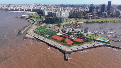 Montevideo-Uruguay,-Aerial-panning-view-of-port-of-Buceo-and-sport-facilities-in-foreground