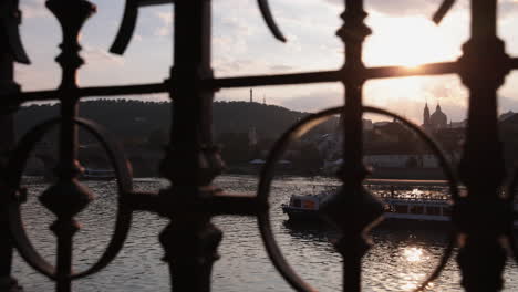 Sun-setting-behing-St-Nicholas-Church-framed-by-iron-fence_Czech-Republic