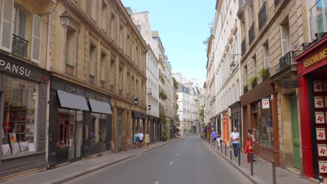 Shot-of-tourists-exploring-Typical-Paris-Street-in-France-during-daytime