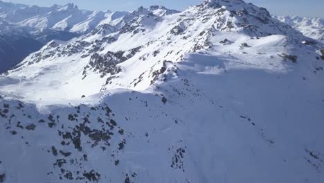 Flying-above-the-ridge-of-Val-Thorens's-mountains,-in-the-French-Alps