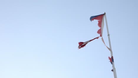 The-flag-of-Cuba-torn-by-the-strong-winds-from-Irma-cyclone-in-Havana,-Cuba