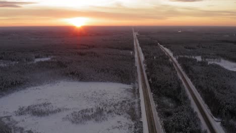 The-beautiful-sunset-over-the-roads-and-treetops-of-Latvia---aerial