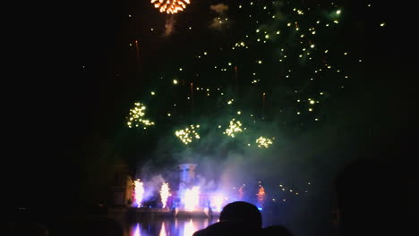 Fireworks-show-at-Retiro-Park-in-Madrid,-Spain,-with-people-in-silhouette