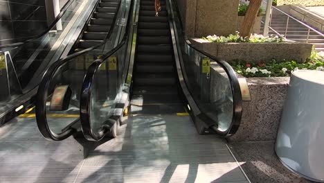 POV-time-lapse-woman-ascend-the-up-escalator-at-CityScape,-Phoneix,-Arizona