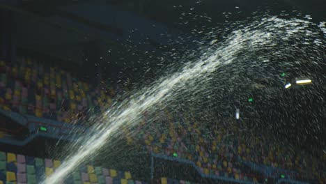 Squirting-water-indoors-inside-a-large-stadium