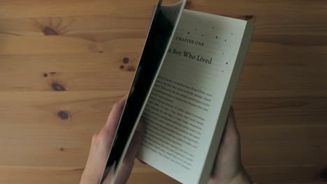 Hands-opening-Harry-Potter-and-the-Philosopher's-Stone-book