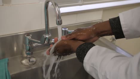 Proper-hand-washing-technique,-step-8:-Rinse-hands-under-running-water-without-exposing-the-hands-to-any-surfaces