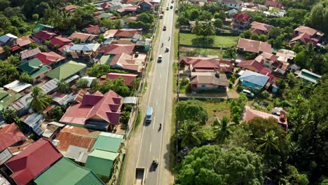 Aerial-Overhead-Pan-of-Evening-Philippine-Road-Traffic-and-Tropical-Houses-4K