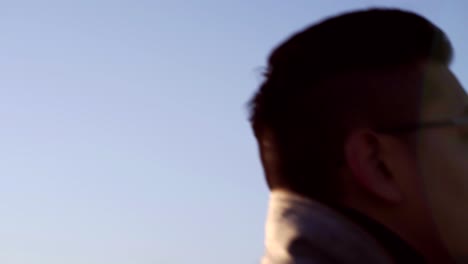 Asian-Korean-professional-looking-man-walking-to-the-bridge-by-the-Camden,-NJ-Waterfront---Wide-pan-shot